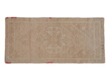 Distressed Oushak runner with a faint, scalloped medallion in soft beige and antique ivory.