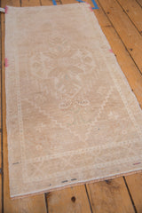 Even low-pile wear showing faint foundation on a distressed vintage Oushak rug runner.