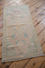 Distressed Oushak runner edge, showing even wear, original selvage, and mint green border.