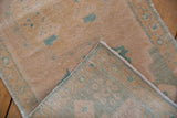 Distressed vintage Oushak rug pile revealing woven foundation in cream and seafoam.