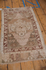 Vintage distressed Turkish Oushak rug, stepped medallion, floral motifs on abrashed ground.