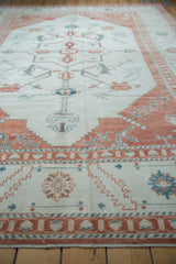 Low-angle view of a distressed Oushak carpet highlighting its soft, evenly worn texture.