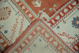 The hand-knotted foundation of a Turkish Oushak rug revealed by a folded corner.