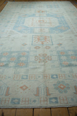 Low angle perspective on a distressed Oushak carpet, highlighting the even wear and soft texture.
