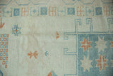 Even wear across the knot heads and visible tinting on a distressed vintage Oushak carpet.