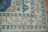 Vintage Oushak rug's stepped corner spandrel and geometric floral border in dusty blue and ivory.