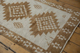 Short, even pile of a vintage Turkish Kars rug with serrated coffee brown medallions.