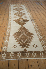 The fully secured end and short, even pile of the distressed vintage Kars rug runner.