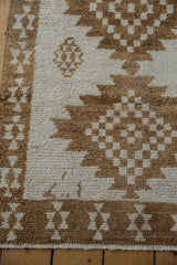 Close-up of the short, even pile on a vintage Kars rug with serrated brown geometric motifs.