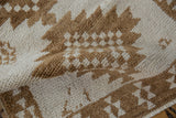 The even, short pile of the hand-knotted Turkish rug in ivory and coffee brown.