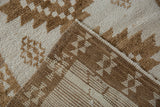 Folded corner of a vintage Kars rug reveals its brown and ivory hand-knotted foundation.