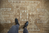 Vintage Distressed Oushak rug showcasing its oversized shield medallion with ram's horn motifs and natural wear.