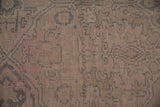 Textured pile of distressed vintage Oushak rug with even wear, soft pink, oxidized silver.