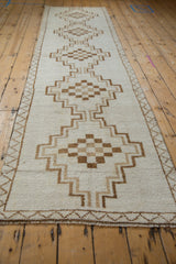 Vintage Kars runner viewed from an angle, highlighting its column of stepped geometric medallions.
