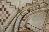 Textured short pile of a vintage Kars rug with brown checkered and stepped-line motifs.