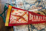Intertwined green felt ties and yellow stitched border on vintage Bradley Field pennant.