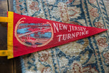 Vintage New Jersey Turnpike felt pennant, yellow border and bridge graphic.
