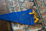 Vintage blue felt pennant edge with yellow ties and white stitching.