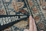 Close-up of the lettering and pointed tip of the vintage Sturbridge, Mass. felt flag.