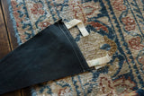 Reverse side of the black felt flag showing its white stitching and hanging tabs.