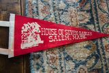 Angled view of the white graphic and text on a vintage Salem, Mass felt pennant.
