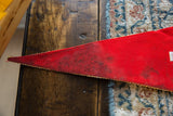 Red felt Niagara Falls pennant tip with gold trim and dark staining.