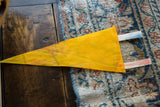 Reverse side of the vintage yellow felt pennant showing its ties and mottled discoloration.