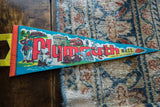 Vibrant retro graphic of a Pilgrim couple and ship on the vintage Plymouth pennant.