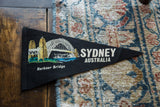 The painted Harbour Bridge graphic on a vintage black wool felt Sydney, Australia flag.