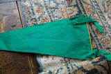 Green felt vintage pennant with yellow trim, showing surface variations and stitched edge.
