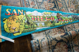 Colorful retro illustration of a tiger and giraffe on the vintage felt pennant.