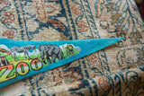 Retro illustrated zebra, elephant, and lion on the vintage San Diego Zoo felt pennant.