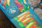 Worn blue felt surface of vintage New York Thruway banner, featuring circular logo and retro text.