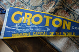 Close-up of vintage Groton felt pennant, showing yellow text, blue felt, and submarine graphic.