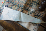 Close-up of the vintage light blue felt flag showing surface discoloration and red stain.