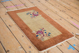 Vintage Nichols Art Deco rug mat with floral vinery shown from a high angle, measuring 1'6
