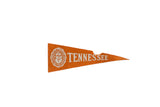 Vintage University of Tennessee felt pennant, orange with white crest and lettering, showing age.