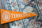 Vintage orange felt University of Tennessee pennant, white school crest, and bold text.