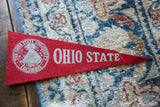 Red vintage Ohio State felt pennant with white university crest and OHIO STATE lettering.
