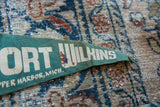 Cracking white letters and age-related staining on the vintage felt flag.