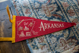 Vintage red felt Arkansas pennant detail showing 'The Wonder State' and state outline graphics.