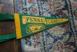 Yellow 'PENNA' lettering and scroll design on green felt with a yellow border.