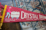Vintage Crystal Iron Mine red felt pennant close-up, miner pushing cart graphic, yellow border.