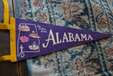 Vintage Alabama felt pennant showing 'The Cotton State' text on purple, with yellow trim.