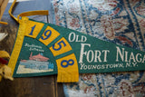 The arched '1958' date and Blockhouse Entrance graphic on the vintage felt flag.