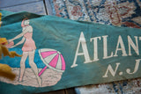 Distressed white 'ATLANTIC N.J.' text on green vintage felt pennant.