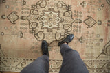 Distressed vintage Oushak carpet showing low pile texture and faded blush tones.