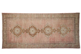 Vintage Distressed Oushak runner with pale rose abrashed field, ivory and bronze medallions, geometric border.
