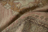 Distressed Oushak runner texture: faded rose, bronze, ivory geometric plant motifs.