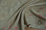 The soft, pliable texture and even, low pile of a distressed hand-knotted Oushak rug.